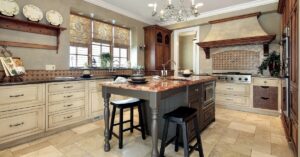 The interior house design of a kitchen with distressed white cabinets and an island from CarrHomes in Hamilton.